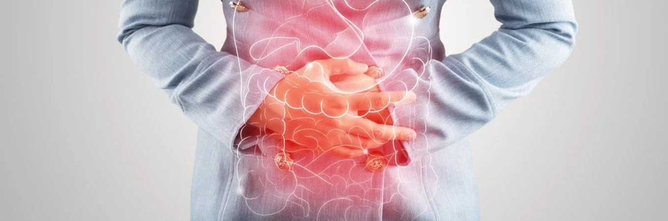 A person in a light blue shirt holds their stomach, with a glowing outline of digestive organs and a red hue indicating discomfort