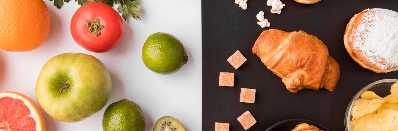 Fresh fruits like oranges, apples, and limes on one side; croissants, pastries, and snacks on a dark background